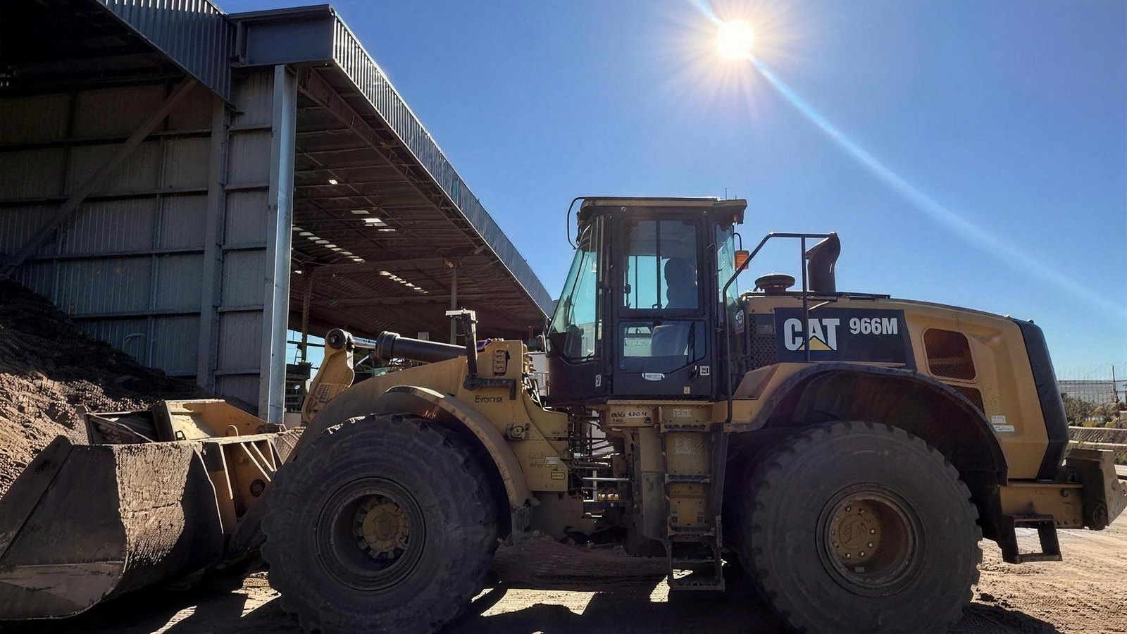 CAT 966M wheel loader on site, wide shot