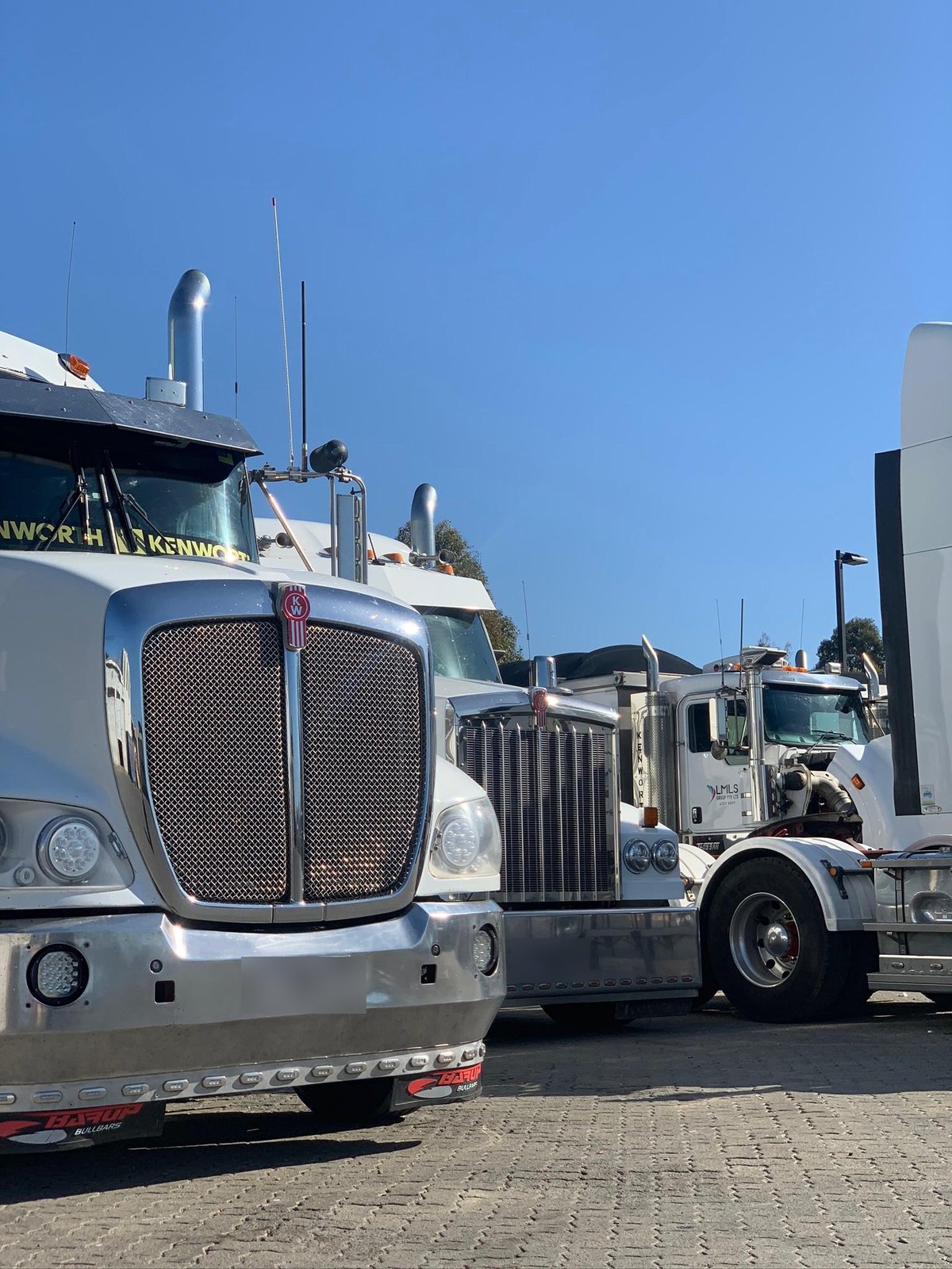 Three Kenworths nose-on, EMTR fleet servicing